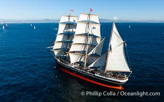 Star of Indian Aerial Photo Under Full Sail Off the Coast of San Diego. The Star of India is a 277' iron-hulled sailing ship built in 1863, and now permanently located in San Diego. It rarely leaves the dock and is seen here under a full compliment of sails off the coast of San Diego, with Tijuana Mexico seen in the distance