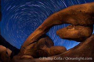 Star trails and Arch Rock. Polaris, the North Star, is at the center of the circular arc star trails as they pass above this natural stone archway in Joshua Tree National Park, Alabama Hills Recreational Area