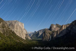 Star trails over Yosemite Valley, viewed from Tunnel View, the floor of Yosemite Valley illuminated by a full moon.  El Capitan on left, Bridalveil Falls on right, Half Dome in distant center, Yosemite National Park, California