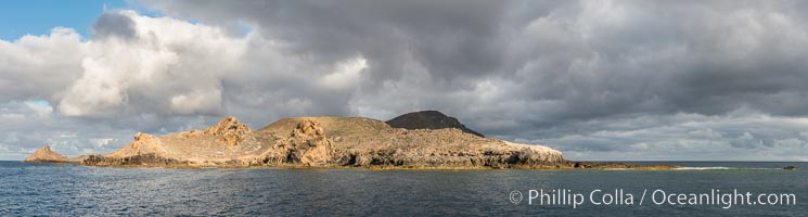 Sunrise at San Clemente Island, south end showing China Hat (Balanced Rock) and Pyramid Head, near Pyramic Cove, storm clouds. Panoramic photo