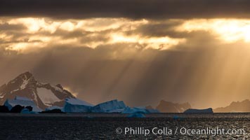 Iceberg, ocean, light and clouds.  Light plays over icebergs and the ocean near Coronation Island.