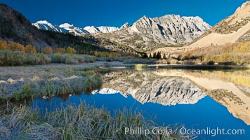 Sunrise on Paiute Peak, reflected in North Lake in the eastern Sierra Nevada, in autumn, Bishop Creek Canyon Sierra Nevada Mountains