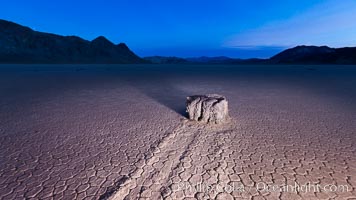 Sunrise on the Racetrack Playa. The sliding rocks, or sailing stones, move across the mud flats of the Racetrack Playa, leaving trails behind in the mud. The explanation for their movement is not known with certainty, but many believe wind pushes the rocks over wet and perhaps icy mud in winter, Death Valley National Park, California