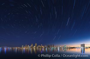 Approaching sunrise and star trails over the San Diego Downtown City Skyline.  In this 60 minute exposure, stars create trails through the night sky over downtown San Diego