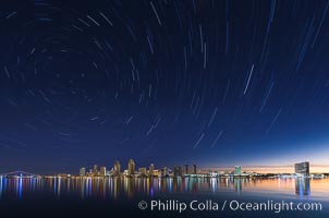 Approaching sunrise and star trails over the San Diego Downtown City Skyline.  In this 60 minute exposure, stars create trails through the night sky over downtown San Diego