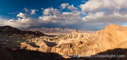 Sunrise at Zabriskie Point, Manly Beacon is lit by the morning sun while clouds from a clearing storm pass by, Death Valley National Park, California