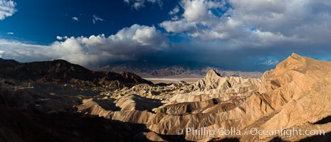 Sunrise at Zabriskie Point, Manly Beacon is lit by the morning sun while clouds from a clearing storm pass by, Death Valley National Park, California