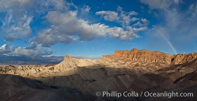 Sunrise at Zabriskie Point, Manly Beacon is lit by the morning sun while clouds from a clearing storm pass by, Death Valley National Park, California