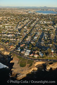 Sunset Cliffs, a coastal community of San Diego, boasts beautiful homes and rugged, scalloped bluffs rising above the Pacific Ocean.  Downtown San Diego can be seen in the distance