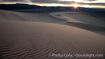 Sunset on the Eureka Dunes.  The Eureka Valley Sand Dunes are California's tallest sand dunes, and one of the tallest in the United States.  Rising 680' above the floor of the Eureka Valley, the Eureka sand dunes are home to several endangered species, as well as "singing sand" that makes strange sounds when it shifts.  Located in the remote northern portion of Death Valley National Park, the Eureka Dunes see very few visitors