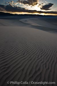 Sunset on the Eureka Dunes.  The Eureka Valley Sand Dunes are California's tallest sand dunes, and one of the tallest in the United States.  Rising 680' above the floor of the Eureka Valley, the Eureka sand dunes are home to several endangered species, as well as "singing sand" that makes strange sounds when it shifts.  Located in the remote northern portion of Death Valley National Park, the Eureka Dunes see very few visitors