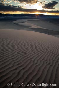 Sunset on the Eureka Dunes.  The Eureka Valley Sand Dunes are California's tallest sand dunes, and one of the tallest in the United States.  Rising 680' above the floor of the Eureka Valley, the Eureka sand dunes are home to several endangered species, as well as "singing sand" that makes strange sounds when it shifts.  Located in the remote northern portion of Death Valley National Park, the Eureka Dunes see very few visitors