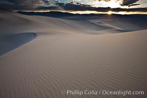 Sunset on the Eureka Dunes.  The Eureka Valley Sand Dunes are California's tallest sand dunes, and one of the tallest in the United States.  Rising 680' above the floor of the Eureka Valley, the Eureka sand dunes are home to several endangered species, as well as "singing sand" that makes strange sounds when it shifts.  Located in the remote northern portion of Death Valley National Park, the Eureka Dunes see very few visitors