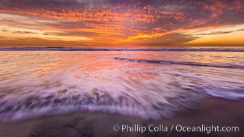 Sunset and incoming surf, gorgeous colors in the sky and on the ocean at dusk, the incoming waves are blurred in this long exposure, Carlsbad, California