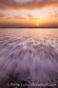 Sunset and incoming surf, gorgeous colors in the sky and on the ocean at dusk, the incoming waves are blurred in this long exposure, Carlsbad, California