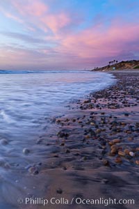 Sunset and incoming surf, gorgeous colors in the sky and on the ocean at dusk, the incoming waves are blurred in this long exposure, Carlsbad, California