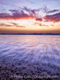 Sunset and incoming surf, gorgeous colors in the sky and on the ocean at dusk, the incoming waves are blurred in this long exposure, Carlsbad, California