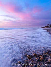 Sunset and incoming surf, gorgeous colors in the sky and on the ocean at dusk, the incoming waves are blurred in this long exposure, Carlsbad, California