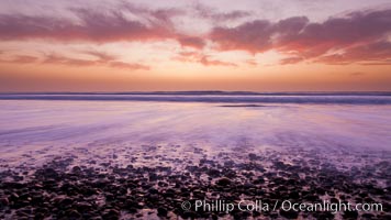 Sunset and incoming surf, gorgeous colors in the sky and on the ocean at dusk, the incoming waves are blurred in this long exposure, Carlsbad, California