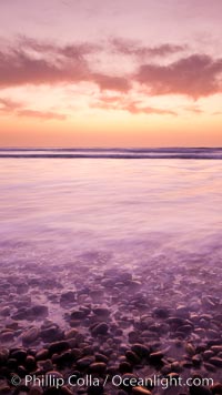 Sunset and incoming surf, gorgeous colors in the sky and on the ocean at dusk, the incoming waves are blurred in this long exposure, Carlsbad, California