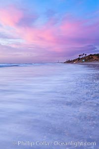 Sunset and incoming surf, gorgeous colors in the sky and on the ocean at dusk, the incoming waves are blurred in this long exposure, Carlsbad, California