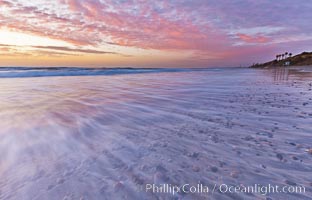 Sunset and incoming surf, gorgeous colors in the sky and on the ocean at dusk, the incoming waves are blurred in this long exposure, Carlsbad, California