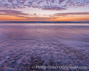 Sunset and incoming surf, gorgeous colors in the sky and on the ocean at dusk, the incoming waves are blurred in this long exposure, Carlsbad, California