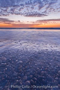 Sunset and incoming surf, gorgeous colors in the sky and on the ocean at dusk, the incoming waves are blurred in this long exposure, Carlsbad, California