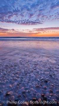 Sunset and incoming surf, gorgeous colors in the sky and on the ocean at dusk, the incoming waves are blurred in this long exposure, Carlsbad, California