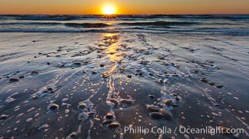Sunset and incoming surf, gorgeous colors in the sky and on the ocean at dusk, the incoming waves are blurred in this long exposure, Carlsbad, California