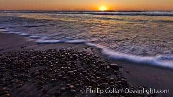 Sunset and incoming surf, gorgeous colors in the sky and on the ocean at dusk, the incoming waves are blurred in this long exposure, Carlsbad, California