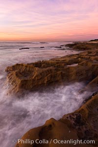 Waves wash over sandstone reef, clouds and sky, La Jolla, California
