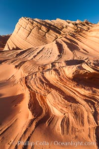 Sandstone "fins", eroded striations that depict how sandstone -- ancient compressed sand -- was laid down in layers over time.  Now exposed, the layer erode at different rates, forming delicate "fins" that stretch for long distances, Navajo Tribal Lands, Page, Arizona