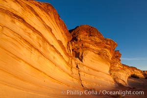 Sandstone "fins", eroded striations that depict how sandstone -- ancient compressed sand -- was laid down in layers over time.  Now exposed, the layer erode at different rates, forming delicate "fins" that stretch for long distances, Navajo Tribal Lands, Page, Arizona