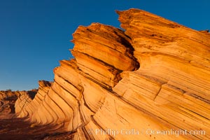 Sandstone "fins", eroded striations that depict how sandstone -- ancient compressed sand -- was laid down in layers over time.  Now exposed, the layer erode at different rates, forming delicate "fins" that stretch for long distances, Navajo Tribal Lands, Page, Arizona