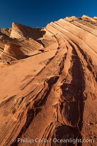 Sandstone "fins", eroded striations that depict how sandstone -- ancient compressed sand -- was laid down in layers over time.  Now exposed, the layer erode at different rates, forming delicate "fins" that stretch for long distances, Navajo Tribal Lands, Page, Arizona