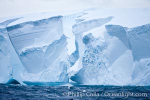 Tabular iceberg.  The edge of a huge tabular iceberg.  Tabular icebergs can be dozens or hundreds of miles in size, have flat tops and sheer sides.