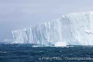 Tabular iceberg.  The edge of a huge tabular iceberg.  Tabular icebergs can be dozens or hundreds of miles in size, have flat tops and sheer sides, Scotia Sea