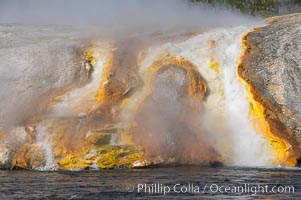 Thermophilac heat-loving bacteria color the runoff canals from Excelsior Geyser as it empties into the Firehole River. Midway Geyser Basin, Yellowstone National Park, Wyoming, USA, natural history stock photograph, photo id 13596