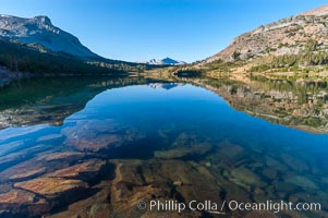Sunrise reflections in Tioga Lake. This spectacular location is just a short walk from the Tioga Pass road. Near Tuolumne Meadows and Yosemite National Park.