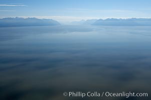 Sunlight dapples Cook Inlet with Turnagain Arm in the distance