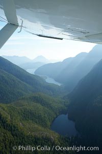 Shelter Inlet of Clayoquot Sound (distance) and small lake (foreground), amid the coastal mountains of western Vancouver Island, aerial photo, Megin Lake