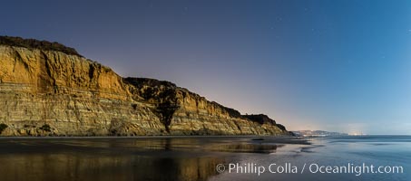 Torrey Pines Cliffs lit at night by a full moon, low tide reflections, Torrey Pines State Reserve, San Diego, California