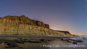 Torrey Pines Cliffs lit at night by a full moon, low tide reflections, Torrey Pines State Reserve, San Diego, California