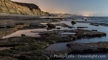 Torrey Pines Cliffs lit at night by a full moon, low tide reflections, Torrey Pines State Reserve, San Diego, California