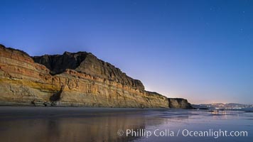 Torrey Pines Cliffs lit at night by a full moon, low tide reflections, Torrey Pines State Reserve, San Diego, California