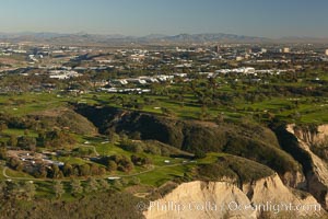 Torrey Pines golf course, situated atop the magnificent 300 foot tall seacliffs, offers majestic views of the Pacific Ocean south to La Jolla.  Scattered around the course are found Torrey pine trees, one of the rare species of pines in the world.  Some of La Jolla's biotechnology companies are seen on the far side of the golf course, along North Torrey Pines Road, San Diego, California