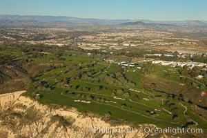 Torrey Pines golf course, situated atop the magnificent 300 foot tall seacliffs, offers majestic views of the Pacific Ocean south to La Jolla.  Scattered around the course are found Torrey pine trees, one of the rare species of pines in the world.  Some of La Jolla's biotechnology companies are seen on the far side of the golf course, along North Torrey Pines Road, San Diego, California