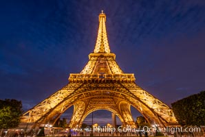 La Tour Eiffel. The Eiffel Tower is an iron lattice tower located on the Champ de Mars in Paris, named after the engineer Gustave Eiffel, who designed the tower in 1889 as the entrance arch to the 1889 World's Fair. The Eiffel tower is the tallest structure in Paris and the most-visited paid monument in the world