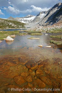 Townsley Lake (10396'), a beautiful alpine lake sitting below blue sky, clouds and Fletcher Peak (right), lies amid the Cathedral Range of glacier-sculpted granite peaks in Yosemite's high country, near Vogelsang High Sierra Camp, Yosemite National Park, California